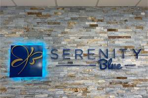 serenity blue stone wall with name and logo